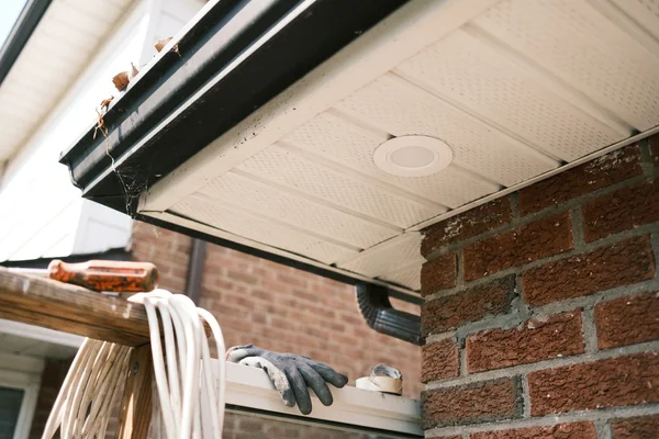 Sealed UV-stable potlight trim in a vinyl soffit