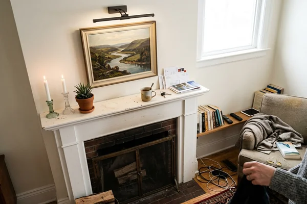 Gimbal potlight washing artwork above a fireplace