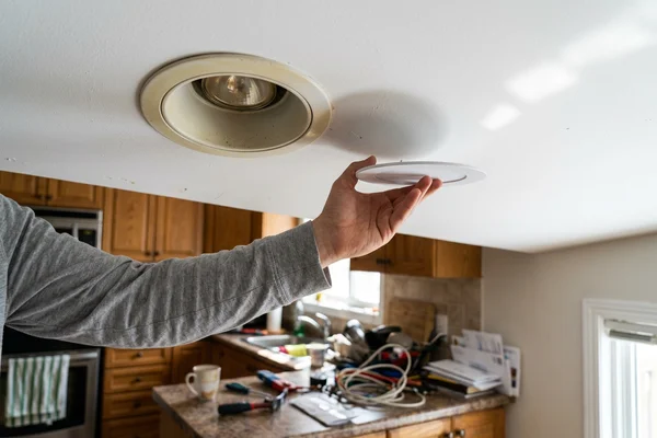 Old halogen pot light compared with a new slim LED wafer