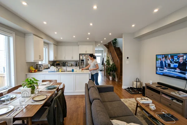 Open-concept main floor with potlights across living and dining areas
