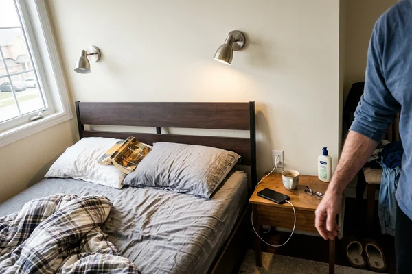 Adjustable reading potlights aimed at each side of a headboard