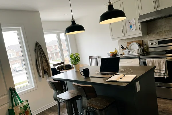 Black metal pendants over a kitchen island in Mississauga