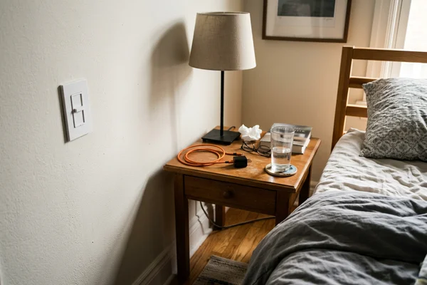 Silent Lutron dimmer and bedside switch beside a nightstand