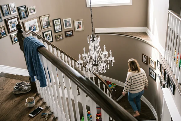 Staircase chandelier on an extension rod seen from the landing