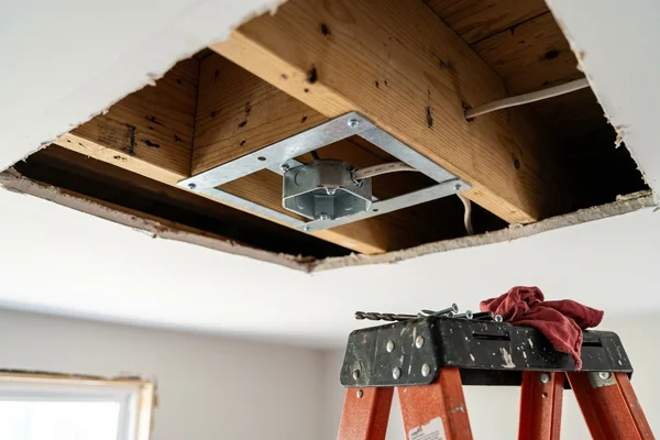 Ceiling box brace between joists before hanging a heavy chandelier